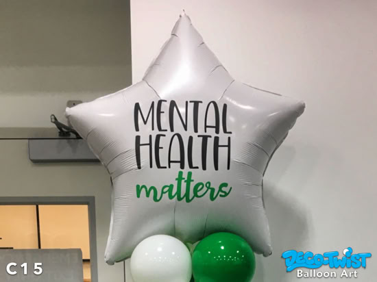 This image shows a large white star-shaped balloon with the words “Mental Health Matters” in custom vinyl lettering on it. The large star balloons sits on top of a spiral balloon column. The setup promotes mental health awareness in a festive and uplifting way.