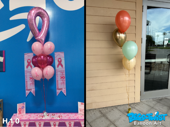 This image shows two different helium balloon bouquets: On the left, a breast cancer awareness-themed bouquet features a large pink foil ribbon balloon on top, with clusters of light pink balloons printed with ribbons, solid pink, and peral Magenta balloons beneath. The setup is surrounded by matching pink banners and table decorations with awareness messages. On the right, a simple and elegant bouquet has four balloons in metallic gold, mint green, peach, and coral, tied together with gold ribbon and anchored to the ground outside a building. The left bouquet is themed and supportive, while the right is subtle and stylish for general decoration.